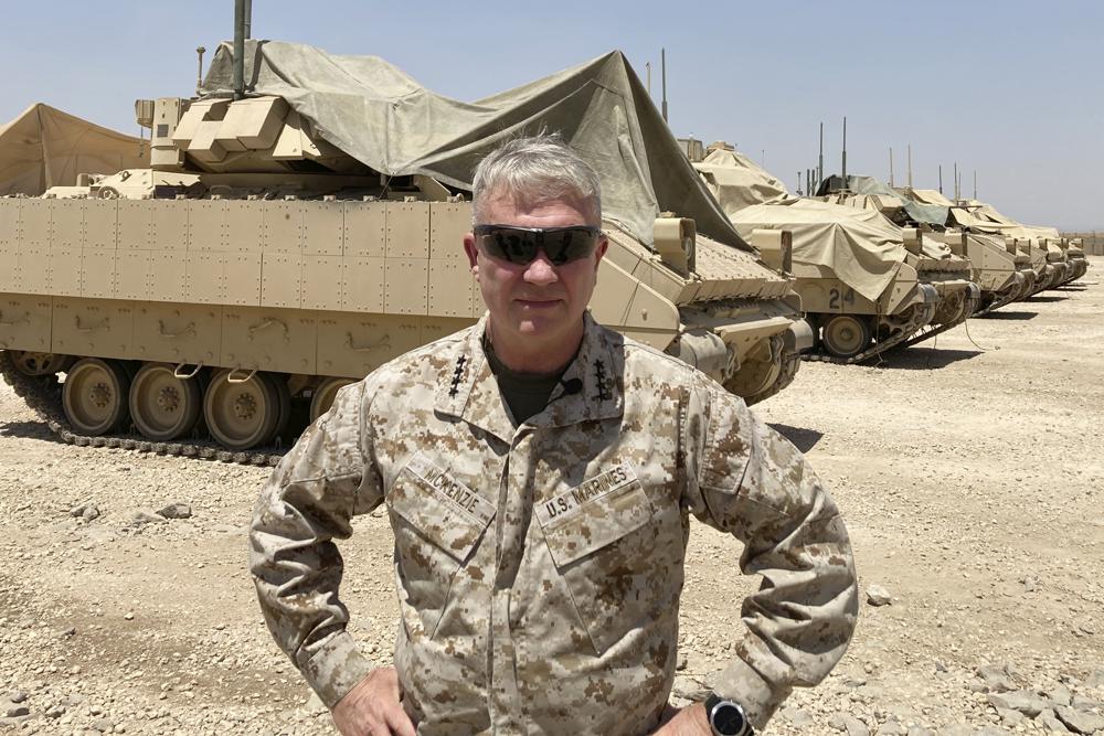 Marine Gen. Frank McKenzie, the top U.S. commander for the Middle East, speaks to the media after arriving in Syria to meet with U.S. and allied commanders and troops, Friday, May 21, 2021. The Iraqi government for the first time is expected to bring home about 100 Iraqi families from a sprawling camp in Syria next week, a move that U.S. officials see as a hopeful sign in the long-frustrated effort to repatriate thousands from the camp, known as a breeding ground for young insurgents. On an unannounced visit to Syria, McKenzie expressed optimism that the transfer from the al-Hol camp will happen. (AP Photo/Lolita C. Baldor)