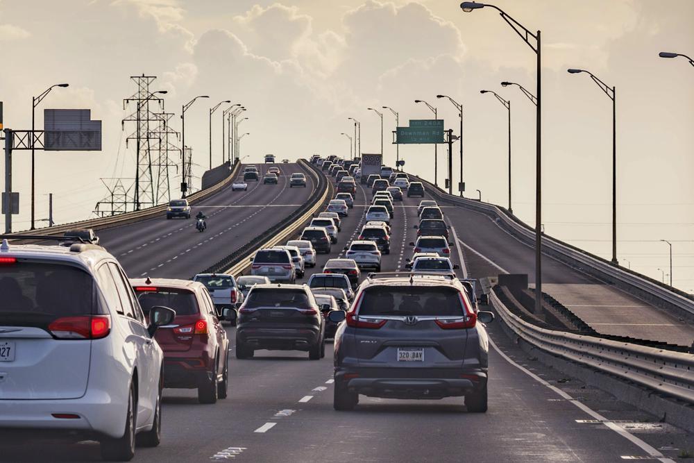 Vehicles head slowly east on the Interstate-10 twin spans leaving New Orleans while only a trickle of cars heads west back into the city before landfall of Hurricane Ida in New Orleans, Saturday, Aug. 28, 2021.    A combination of voluntary and mandatory evacuations have been called for cities and communities across the region including New Orleans, where the mayor ordered a mandatory evacuation for areas outside the city’s levee system and a voluntary evacuation for residents inside the levee system.(AP Photo/Matthew Hinton)