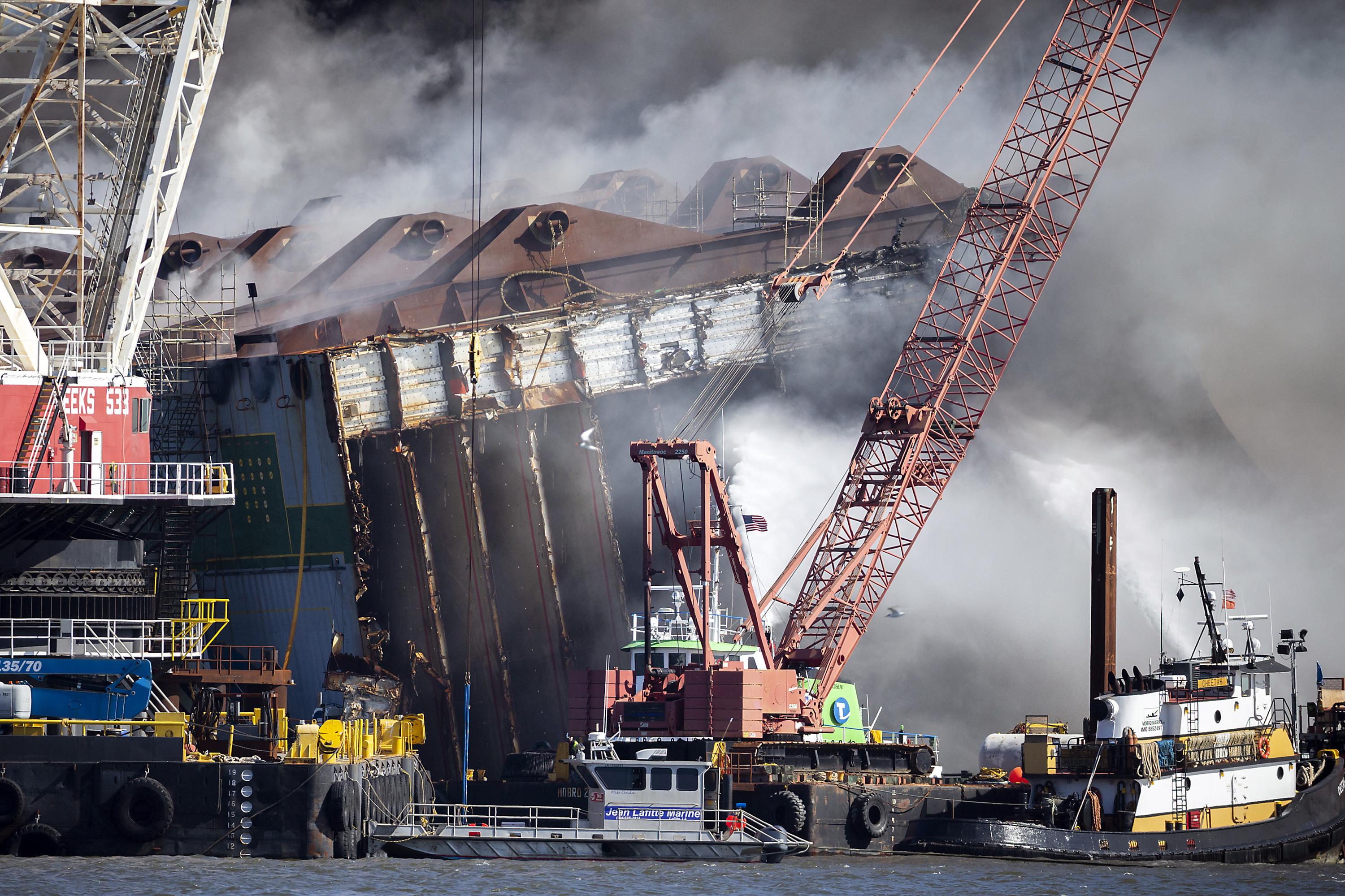 Damage assessment begins on overturned cargo ship after fire AP News