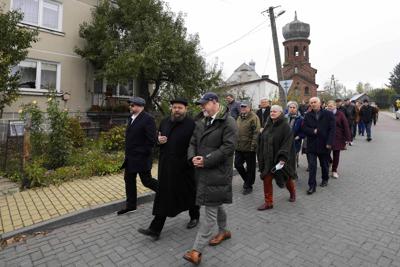 Decenas de personas se dirigen el sitio donde unos 60 judíos fueron asesinados por los nazis durante la Segunda Guerra Mundial para rendirles homenaje en Wojslawice, Polonia, el 14 de octubre del 2021. (AP Photo/Czarek Sokolowski)