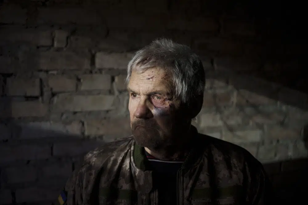 Anatolii Kaharlytskyi, 73, stands inside his house, heavily damaged after a Russian attack in Kyiv, Ukraine, Monday, Jan. 2, 2023. Kaharlytskyi was injured and his daughter Iryna died in the attack on Dec. 31, 2022. (AP Photo/Renata Brito)