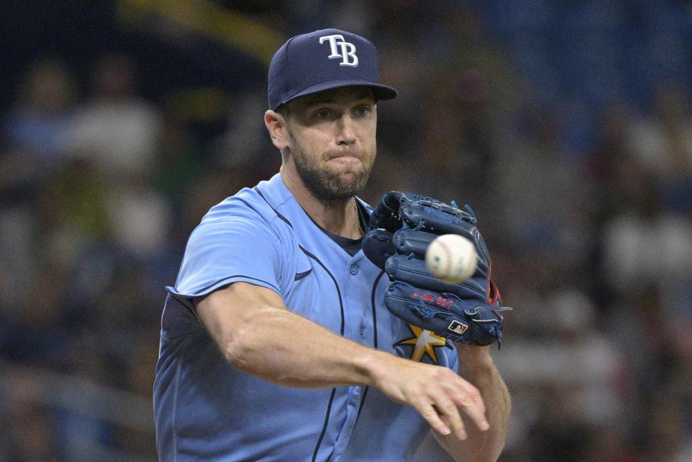 Tampa Bay Rays relief pitcher Jason Adam attempts to pick off Boston Red Sox's Trevor Story at first base during the fifth inning of a baseball game, Saturday, April 23, 2022, in St. Petersburg, Fla. (AP Photo/Phelan M. Ebenhack)