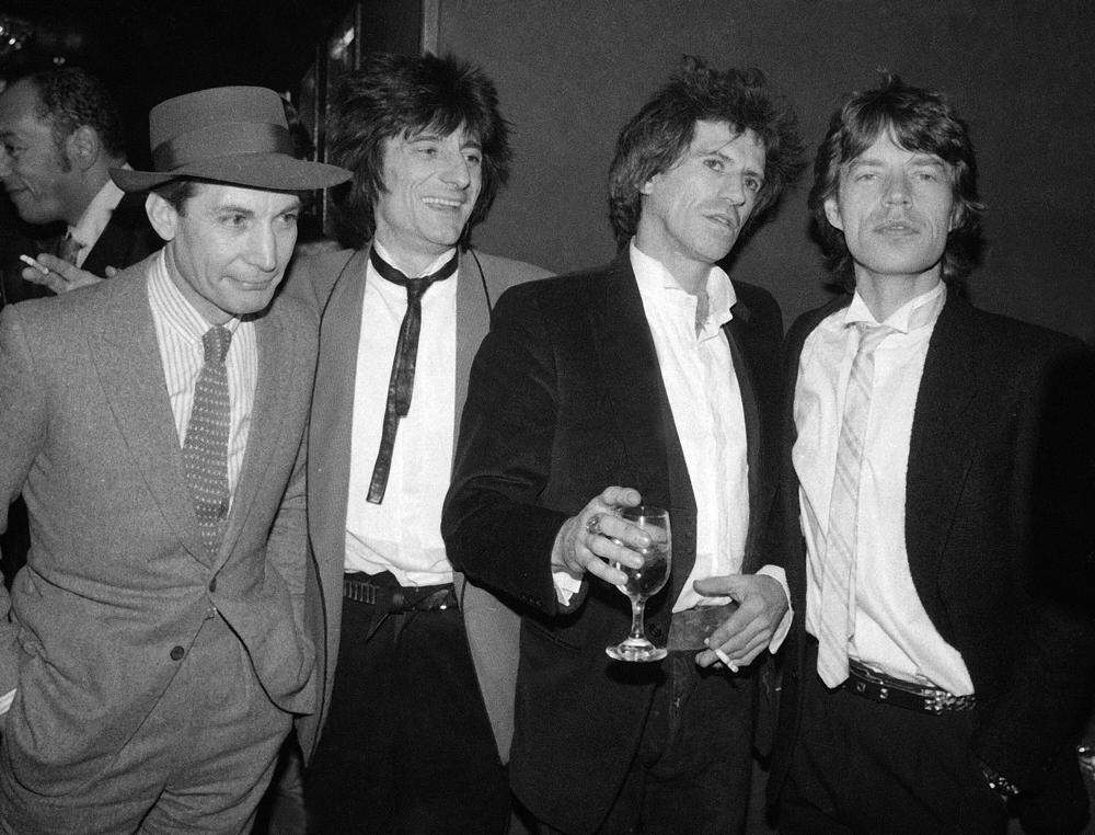 FILE - Members of the Rolling Stones, from left, Charlie Watts, Ron Wood, Keith Richards, and Mick Jagger appear at a party celebrating the opening of their film "Let's Spend The Night Together," in New York on Jan. 18, 1983. Watts' publicist, Bernard Doherty, said Watts passed away peacefully in a London hospital surrounded by his family on Tuesday, Aug. 24, 2021. He was 80. (AP Photo/Carlos Rene Perez, File)