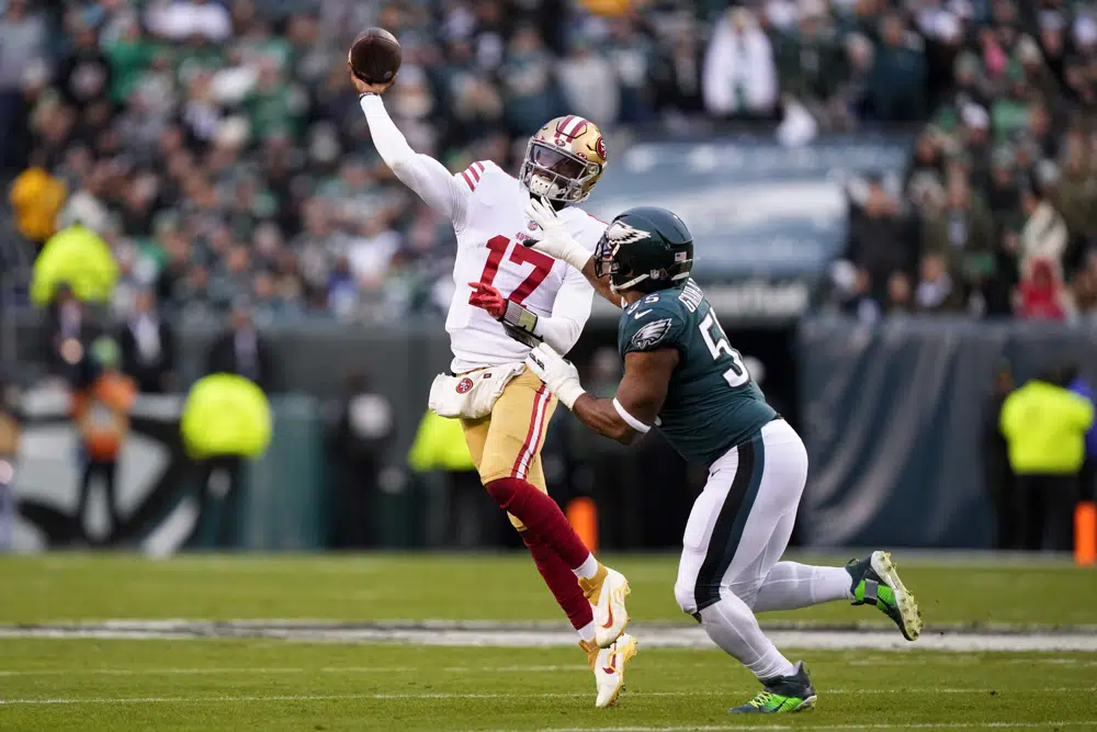 San Francisco 49ers quarterback Josh Johnson, left, passes under pressure from Philadelphia Eagles defensive end Brandon Graham during the first half of the NFC Championship NFL football game between the Philadelphia Eagles and the San Francisco 49ers on Sunday, Jan. 29, 2023, in Philadelphia. (AP Photo/Matt Rourke)