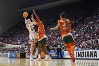 Indiana's Mackenzie Holmes (54) shoots against Miami's Kyla Oldacre (44) during the first half of a second-round college basketball game in the women's NCAA Tournament Monday, March 20, 2023, in Bloomington, Ind. (AP Photo/Darron Cummings)