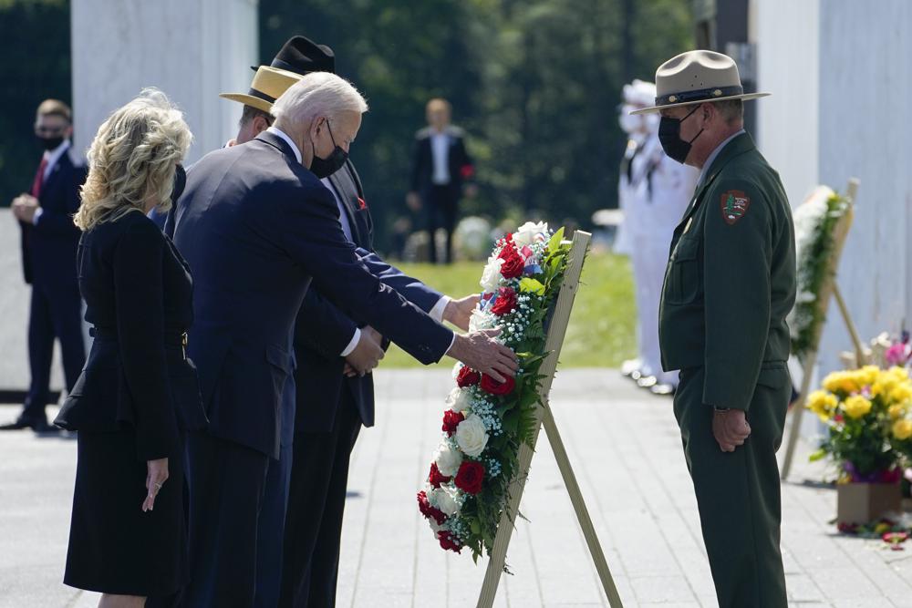 President Joe Biden and first lady Jill Biden lay a wreath at the Wall of Names during a visit to the Flight 93 National Memorial in Shanksville, Pa., Saturday, Sept. 11, 2021. The Bidens visited to commemorate the 20th anniversary of the Sept. 11, 2001, terrorist attacks. National Park Service park ranger Robert Franz stands at right. (AP Photo/Evan Vucci)