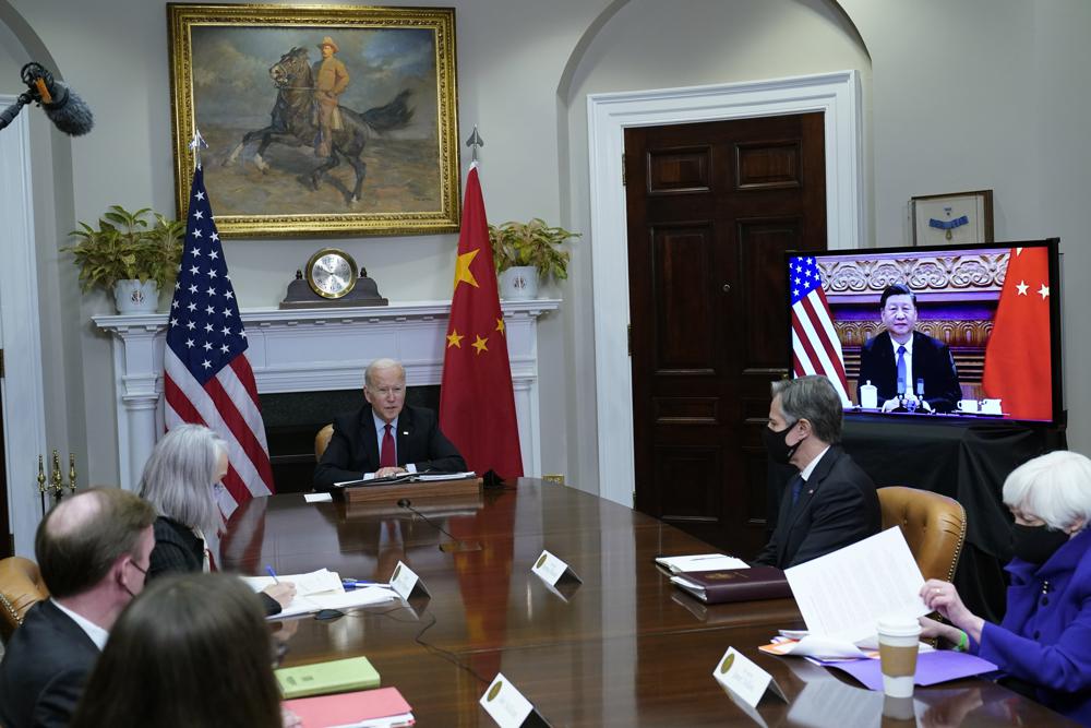 President Joe Biden meets virtually with Chinese President Xi Jinping from the Roosevelt Room of the White House in Washington, Monday, Nov. 15, 2021, as Treasury Secretary Janet Yellen, right, and Secretary of State Antony Blinken listen. (AP Photo/Susan Walsh)