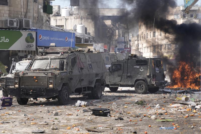 Smoke from fires fills the air as Palestinians clash with Israeli forces in the West Bank city of Nablus, Wednesday, Feb. 22, 2023. Israeli troops moved into the city, setting off fighting that killed several Palestinians, including a 72-year-old man, Palestinian health officials said. The Israeli military gave few details about its operation in the northern city, which is known as a militant stronghold, and the army frequently operates there. (AP Photo/Majdi Mohammed)