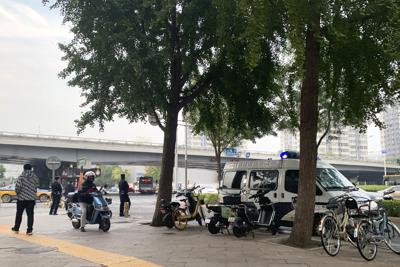 Un vehículo policial se ve estacionado cerca de un puente donde, según videos en medios sociales, antes se habrían visto humo y carteles de protesta en Beijing, el jueves 13 de octubre de 2022. (AP Foto/Dake Kang)