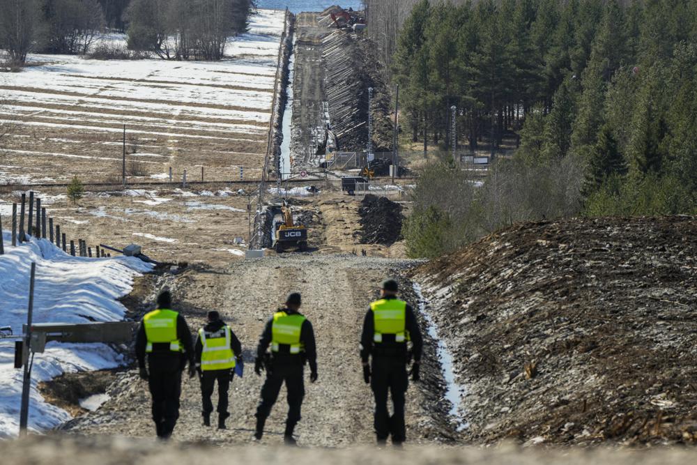 Finland's border guards stay at construction site of the border barrier fence between Finland and Russia near Pelkola border crossing point in Imatra, south-eastern Finland, Friday, April 14, 2023. (AP Photo/Sergei Grits)