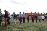 Kenyans queue to receive the AstraZeneca coronavirus vaccine donated by Britain, at the Makongeni Estate in Nairobi, Kenya Saturday, Aug. 14, 2021. In late June, the international system for sharing coronavirus vaccines sent about 530,000 doses to Britain – more than double the amount sent that month to the entire continent of Africa. It was the latest example of how a system that was supposed to guarantee low and middle-income countries vaccines is failing, leaving them at the mercy of haphazard donations from rich countries. (AP Photo/Brian Inganga)