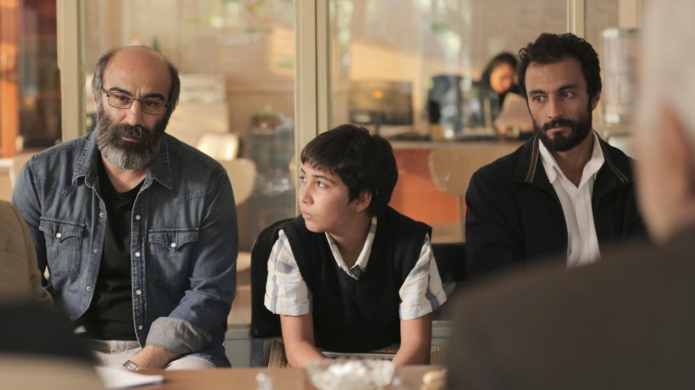 This image provided by Amazon Studios shows Mohsen Tanabandeh, from left, Saleh Karimai and Amir Jadidi in a scene from "A Hero." (Amazon Studios via AP)