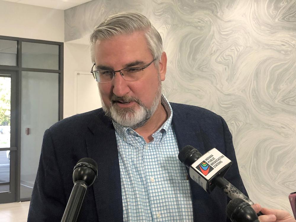 Indiana Gov. Eric Holcomb speaks with reporters during the Indiana Technology and Innovation Association conference in Fishers, Ind., on Friday, Oct. 8, 2021. Holcomb said he had not yet decided whether to appeal a court decision against his lawsuit challenging the expanded power state legislators gave themselves to intervene during public health emergencies. (AP Photo/Tom Davies)