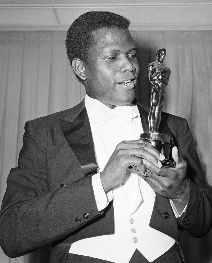 FILE - Actor Sidney Poitier poses with his Oscar for best actor for "Lillies of the Field" at the 36th Annual Academy Awards in Santa Monica, Calif. on April 13, 1964. Poitier, the groundbreaking actor and enduring inspiration who transformed how Black people were portrayed on screen, became the first Black actor to win an Academy Award for best lead performance and the first to be a top box-office draw, died Thursday, Jan. 6, 2022 in the Bahamas. He was 94. (AP Photo, File)