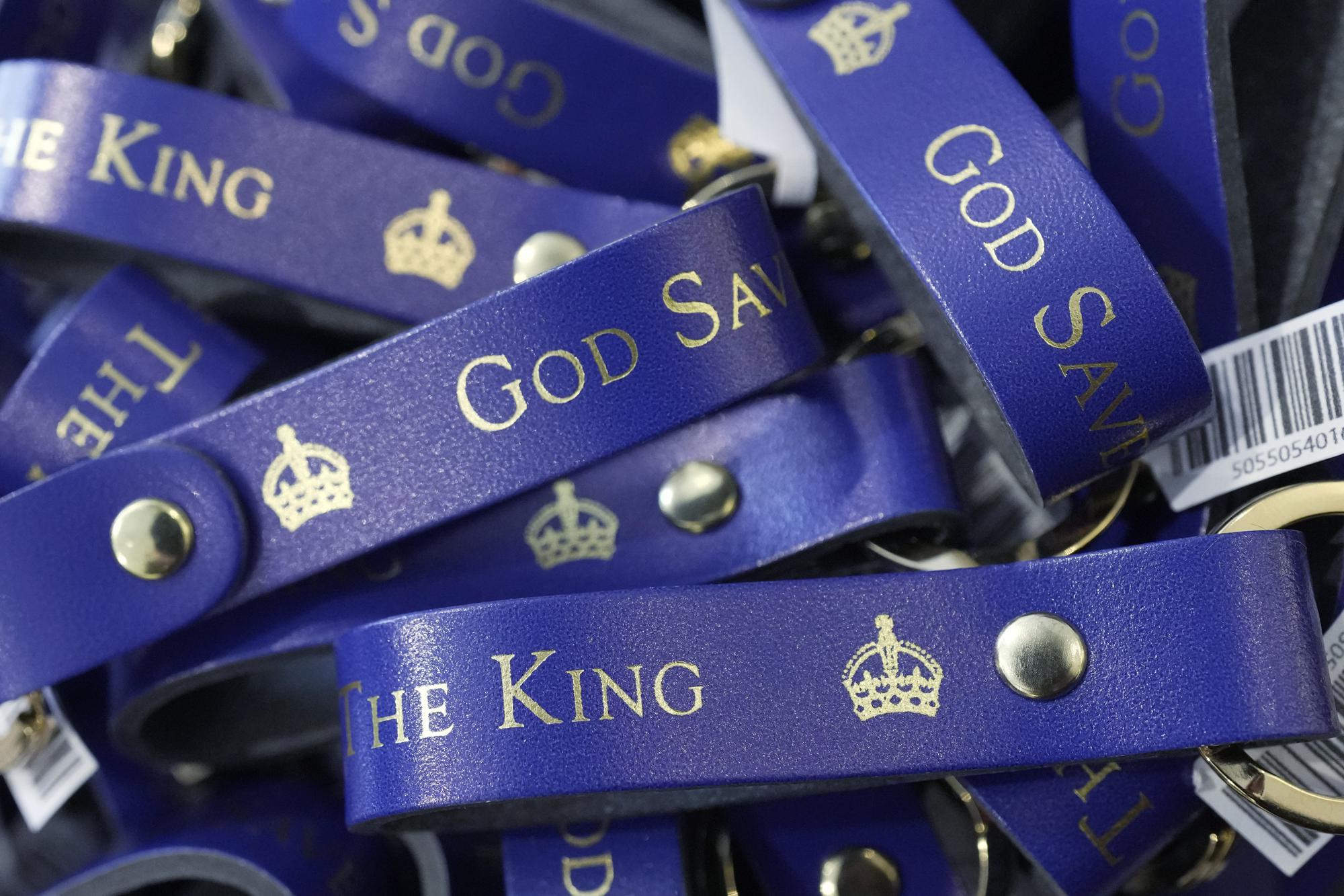 Souvenirs are displayed for sale in a gift shop ahead of King Charles III's Coronation in London, Monday, April 24, 2023. The May 6 coronation is luring royal fans and far-flung visitors fascinated by the ceremonial spectacle — and drama — of the monarchy and eager to experience a piece of British history. Tour companies, shops and restaurants are rolling out the red carpet, whether it's a decked-out bus tour of London's top sights boasting high tea or merchandise running from regal to kitschy. (AP Photo/Kin Cheung)