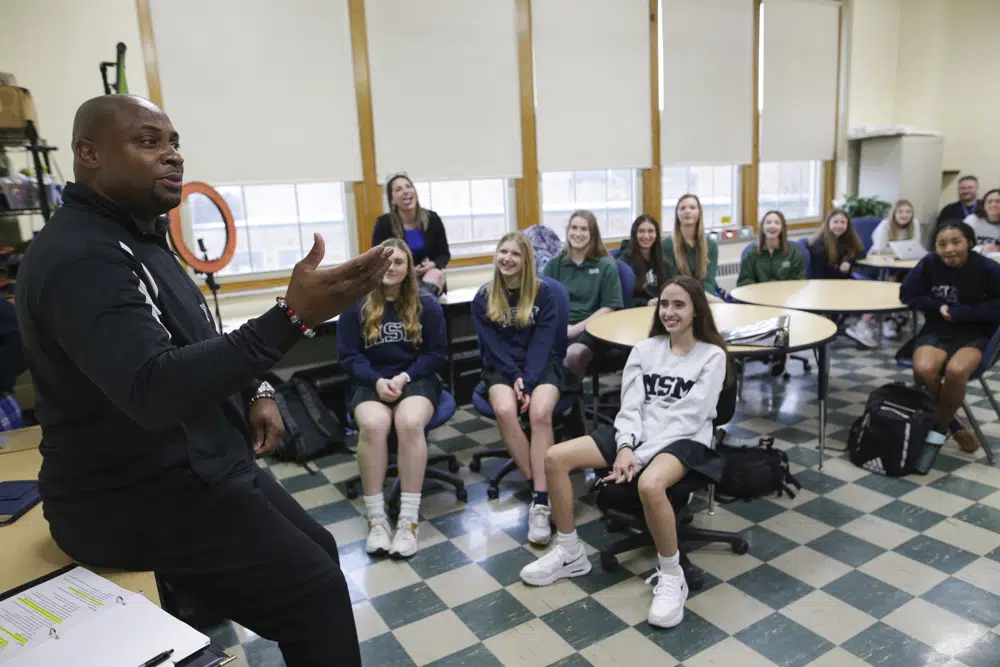 Troy Vincent, NFL Executive Vice President of Football Operations, left, talks with students at Mount St. Mary Academy on Wednesday, Jan. 18, 2023, in Kenmore, N.Y. (AP Photo/Joshua Bessex)