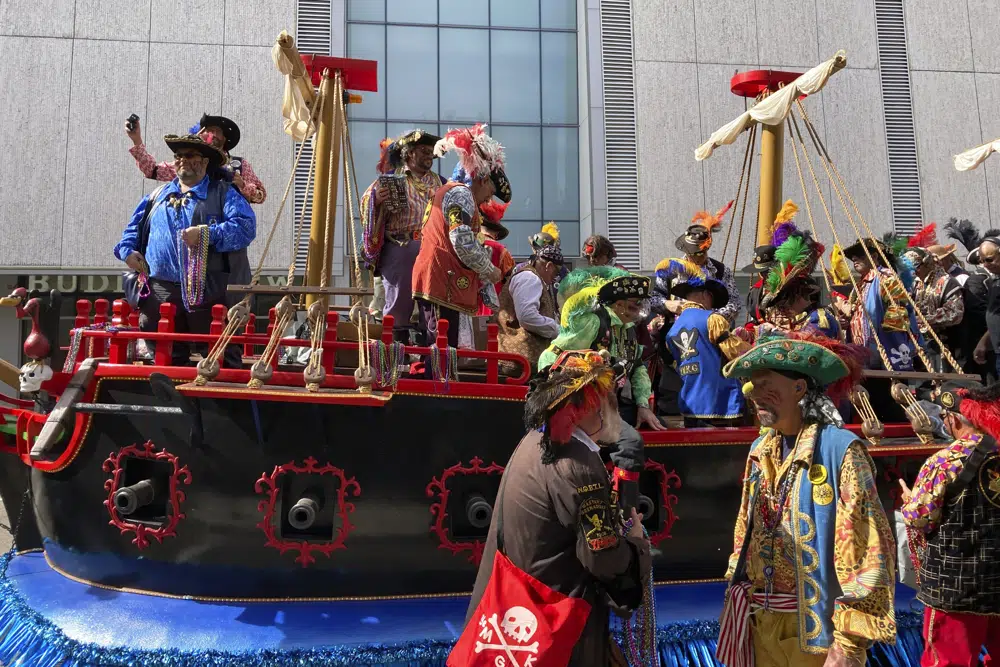 Members of Ye Mystic Krewe of Gasparilla arrive at Tampa, Fla., City Hall to "demand the key to the city" from Mayor Jane Castor, not pictured, Tuesday, Jan. 24, 2023, as a prelude to the weekend's Gasparilla Pirate Festival. (AP Photo/Curt Anderson)