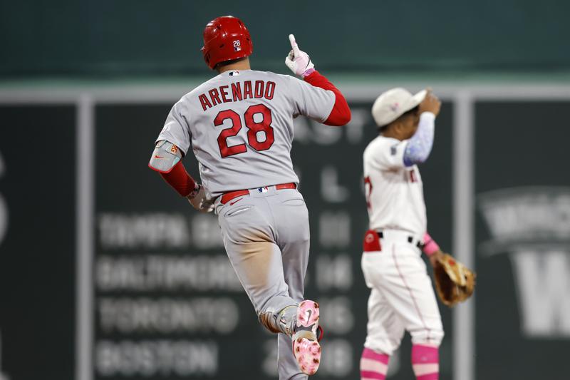 St. Louis Cardinals' Nolan Arenado (28) rounds the bases on his two-run home run past Boston Red Sox's Enmanuel Valdez, right, during the eighth inning of a baseball game, Sunday, May 14, 2023, in Boston. (AP Photo/Michael Dwyer)