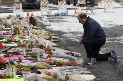 Colorado governor visits shooting site as community heals | AP News