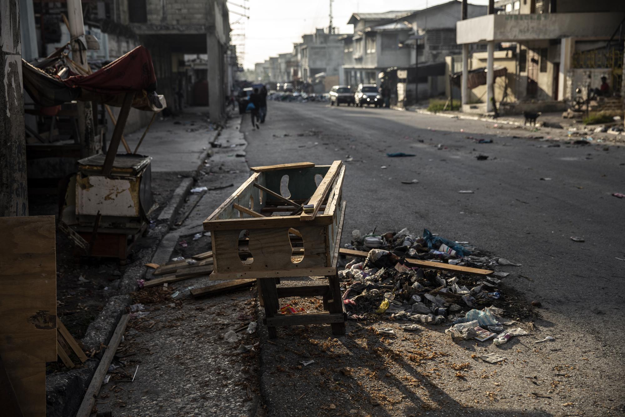 An unfinished coffin sits outside a carpentry shop near an area controlled by gangs in downtown Port-au-Prince, Haiti, Tuesday, Sept. 14, 2021. (AP Photo/Rodrigo Abd)