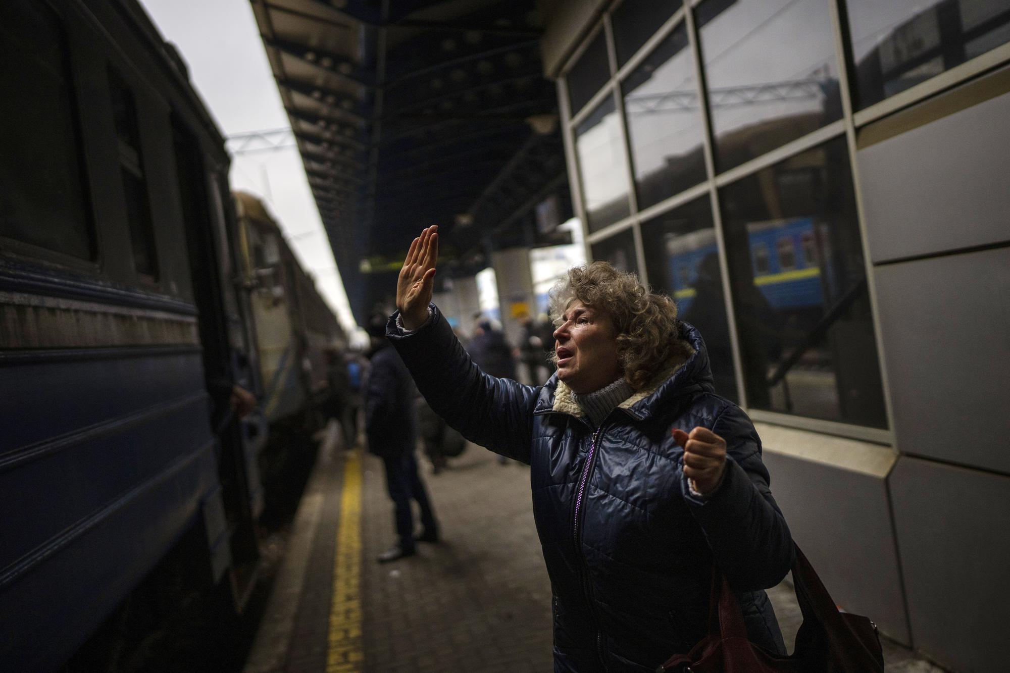 Natalia, 57, says goodbye to her daughter and grandson on a train to Lviv at the Kyiv station, Ukraine, Thursday, March 3. 2022. (AP Photo/Emilio Morenatti)