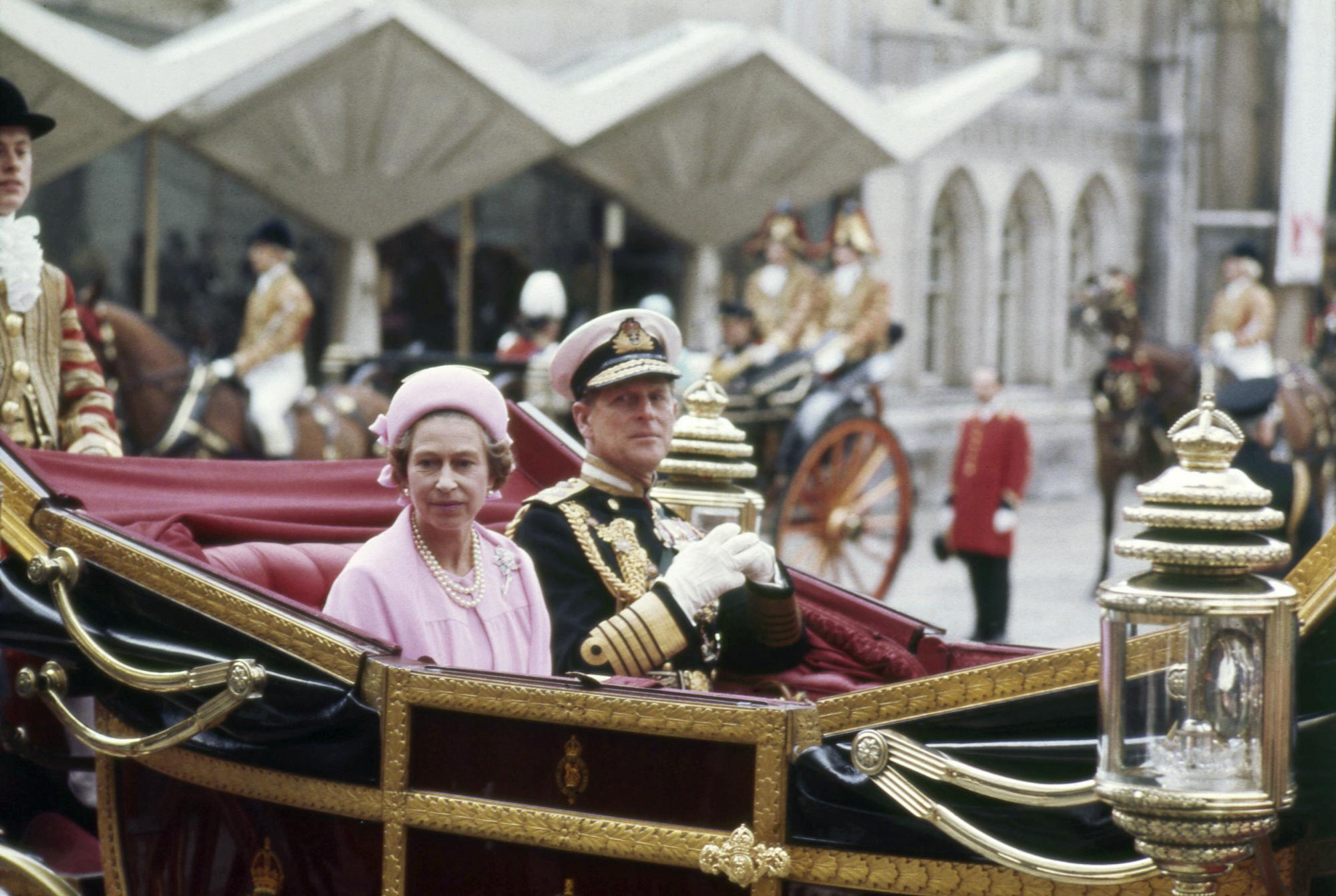 FILE - Britain's Queen Elizabeth II and Prince Philip, the Duke of Edinburgh travel in a carriage during celebrations for the Silver Jubilee in London, June 7 1977. Queen Elizabeth II, Britain’s longest-reigning monarch and a rock of stability across much of a turbulent century, has died. She was 96. Buckingham Palace made the announcement in a statement on Thursday Sept. 8, 2022 (AP Photo, File)