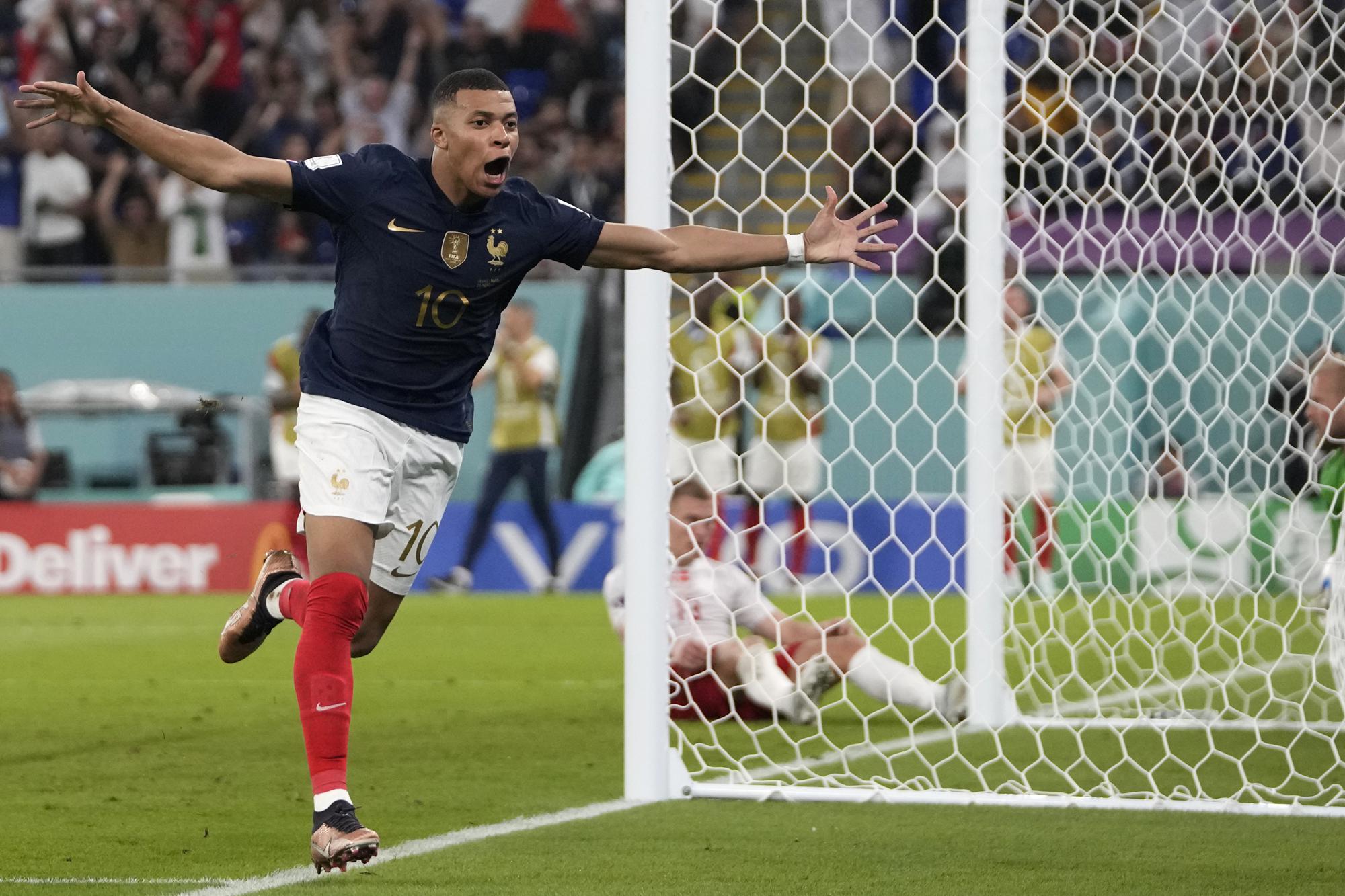 France's Kylian Mbappe celebrates after scoring his sides second goal during the World Cup group D soccer match between France and Denmark, at the Stadium 974 in Doha, Qatar, Saturday, Nov. 26, 2022. (AP Photo/Thanassis Stavrakis)