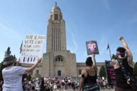 FILE - Protesters line the street around the front of the Nebraska State Capitol during an Abortion Rights Rally held on July 4, 2022, in Lincoln, Neb. A Nebraska woman has been charged in early June with helping her teenage daughter end her pregnancy at about 24 weeks after investigators uncovered Facebook messages in which the two discussed using medication to induce an abortion and plans to burn the fetus afterward. (Kenneth Ferriera/Lincoln Journal Star via AP, File)
