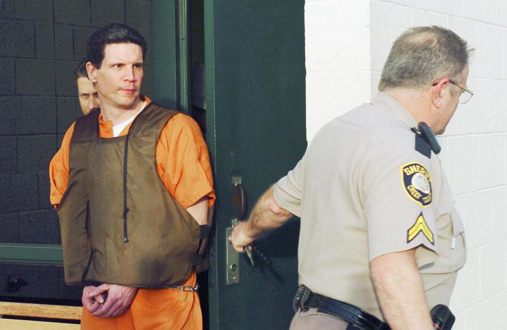 FILE - Scott Eizember, left, is taken out of the Canadian County Jail by members of the Creek County Sheriff's Office after a jury approved the death penalty Eizember, Friday, Feb. 25, 2005, in El Reno, Okla. The Oklahoma Court of Criminal Appeals on Friday, July 1, 2022, set execution dates for six death row inmates, just hours before an attorney for one planned to ask for a rehearing in his case. Execution dates for James Coddington, Richard Glossip, Benjamin Cole, Richard Fairchild, John Hanson and Scott Eizember were scheduled, starting Aug. 25 with Coddington and followed on Sept. 22 with Glossip(AP Photo/The Oklahoman, Michael Downes File)