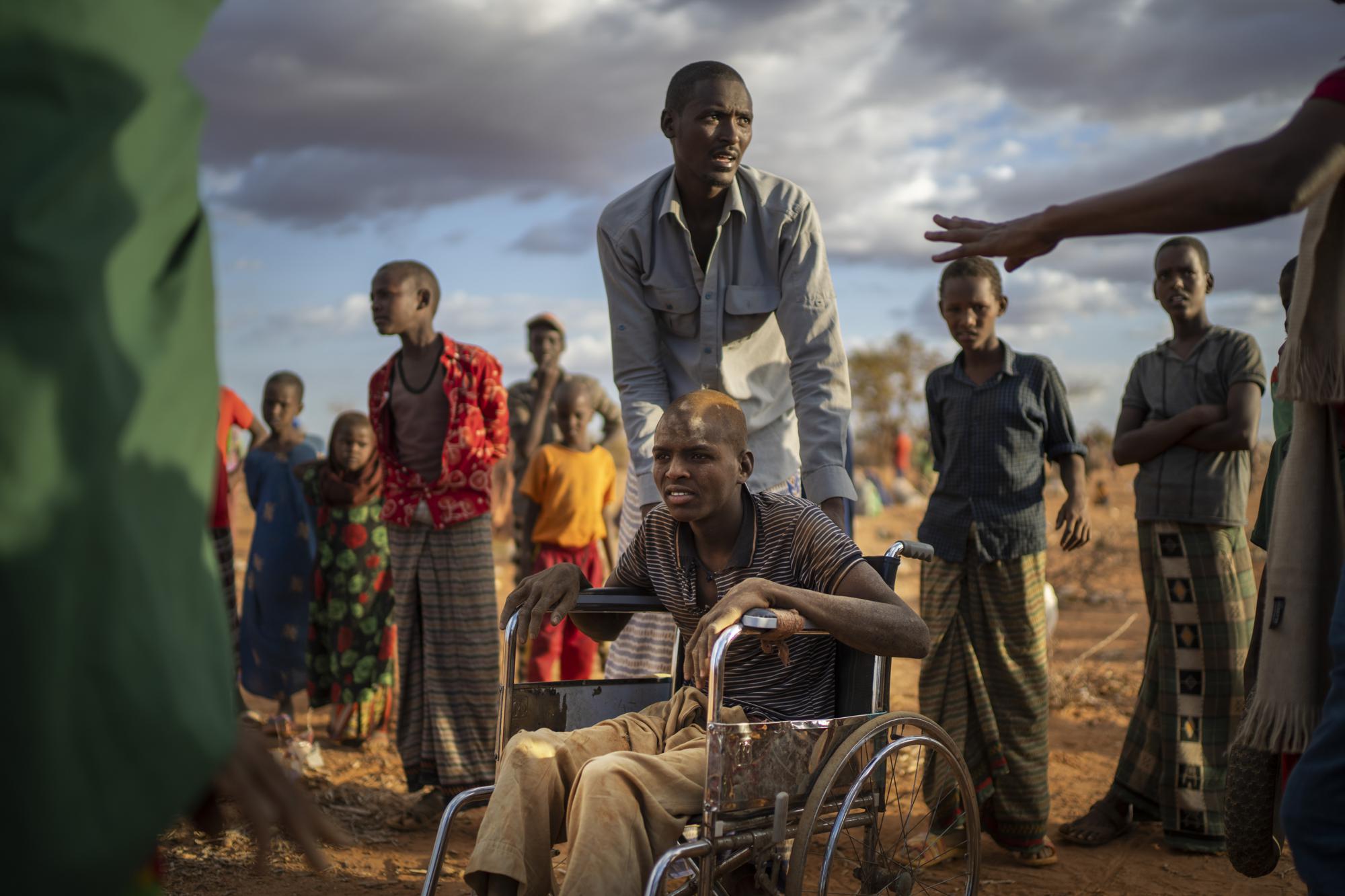 Displaced people who have arrived at a camp wait for plot allocation on the outskirts of Dollow, Somalia, on Monday, Sept. 19, 2022.  Somalia is in the midst of the worst drought anyone there can remember. A rare famine declaration could be made within weeks. Climate change and fallout from the war in Ukraine are in part to blame. (AP Photo/Jerome Delay)