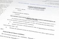 Pages from a court filing by the Justice Department and former President Donald Trump's legal team of proposed candidates to server as an independent arbiter in the investigation into top-secret information seized by the FBI during a search of Trump's Mar-a-Lago estate, is photographed Thursday, Sept. 8, 2022. (AP Photo/Jon Elswick)