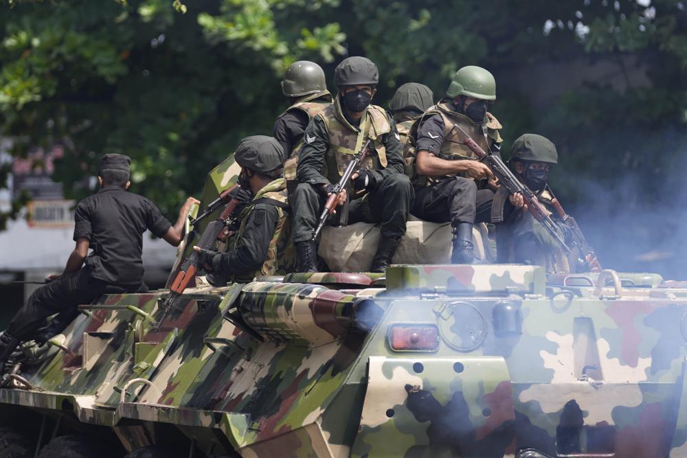 Sri Lankan army soldiers patrol during curfew in Colombo, Sri Lanka, Wednesday, May 11, 2022. Sri Lanka's defense ministry ordered security forces on Tuesday to shoot anyone causing injury to people or property to contain widespread arson and mob violence targeting government supporters. (AP Photo/Eranga Jayawardena)