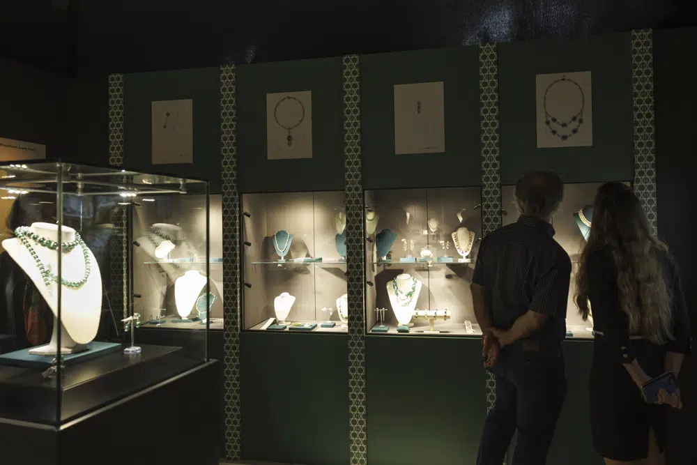 Visitors look of the Bulgari jewels displayed in display case during the exhibition of "The World of Heidi Horten" the 700 piece jewellery collection of the late Austrian billionaire Heidi Horten, at Christie's Auction House in Geneva, Switzerland, Monday, May 8, 2023. (Salvatore Di Nolfi/Keystone via AP)