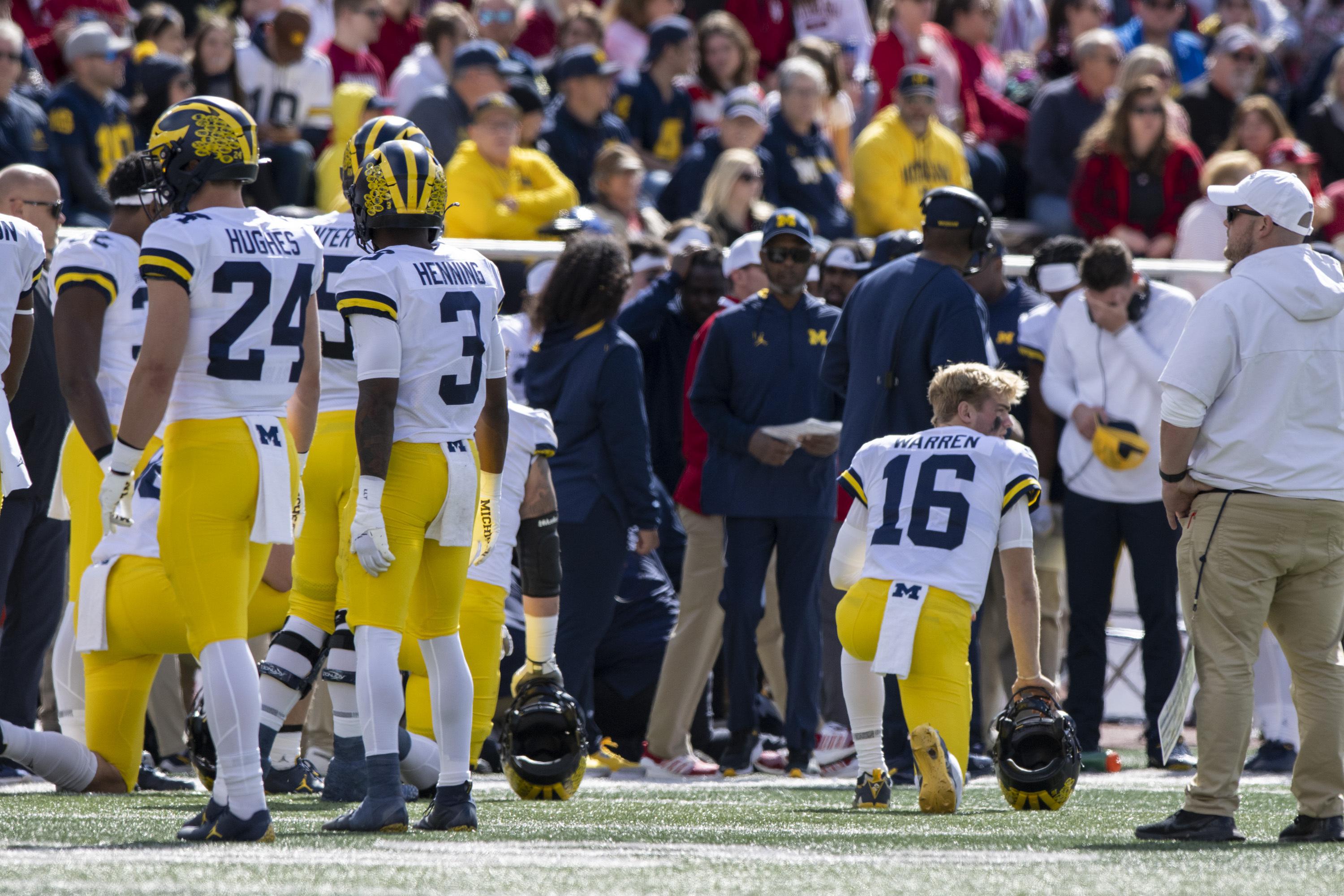 Michigan assistant coach Hart carted off field on backboard | AP News