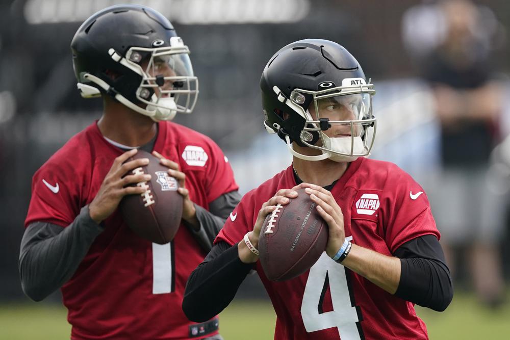 Atlanta Falcons quarterbacks Desmond Ridder (4) and Marcus Mariota (1) work during their NFL minicamp football practice Tuesday, June 14, 2022, in Flowery Branch, Ga. (AP Photo/John Bazemore)