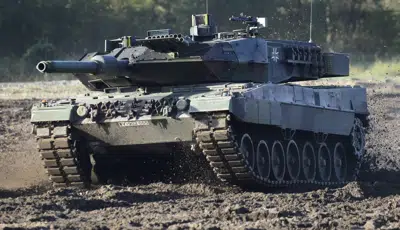 FILE - A Leopard 2 tank is pictured during a demonstration event held for the media by the German Bundeswehr in Munster near Hannover, Germany, Wednesday, Sept. 28, 2011. Poland will apply to the German government for permission to supply the German-made Leopard battle tanks to Ukraine. (AP Photo/Michael Sohn, File)