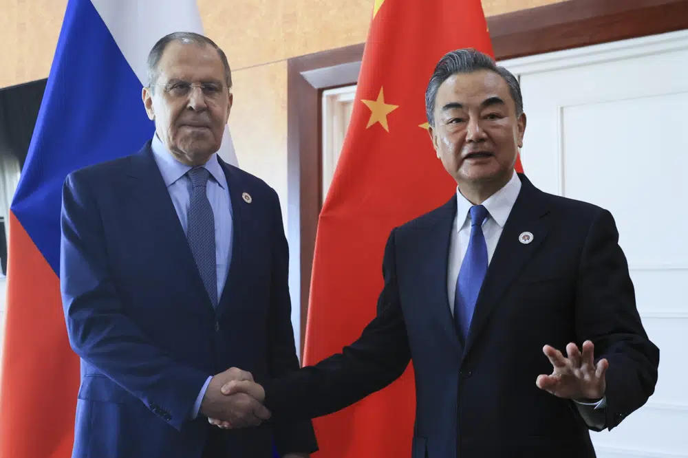 FILE - In this photo released by the Russian Foreign Ministry Press Service, Russian Foreign Minister Sergey Lavrov, left, and Chinese Foreign Minister Wang Yi pose for a photo prior to their talks on the sideline of the 12th East Asia Summit foreign ministers' meeting in Phnom Penh, Cambodia, on Aug. 5, 2022. Wang defended his country's position on the war in Ukraine on Sunday, Dec. 25, and signaled that China would deepen ties with Russia in the coming year while striving to bring US China ties back on the right course. (Russian Foreign Ministry Press Service via AP, File)