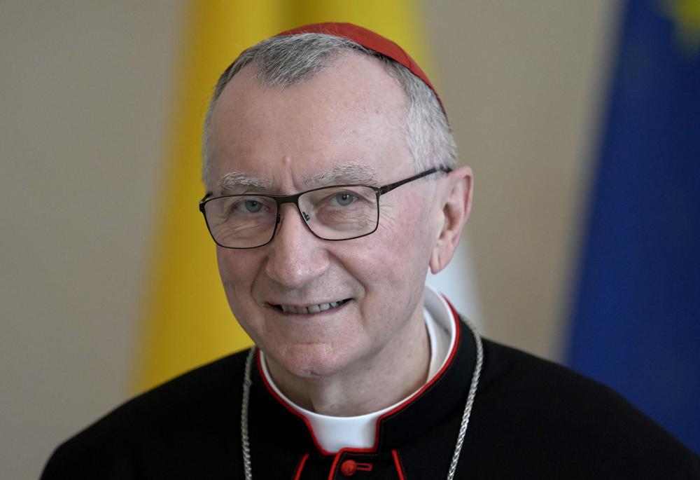 FILE - Vatican Secretary of State Cardinal Pietro Parolin smiles during a meeting at the Bellevue palace in Berlin, Germany on June 29, 2021. The Vatican press office says that The Vatican secretary-of-state and his deputy have both tested positive for the new coronavirus. Officials said Tuesday, Jan. 18, 2022, that Cardinal Pietro Parolin, the pope’s No. 2, has “very light” symptoms, while Mons. Edgar Pena Parrra is asymptomatic. These are the first cases of COVID confirmed so high up in the Vatican hierarchy since the pandemic began. (AP Photo/Michael Sohn, File)