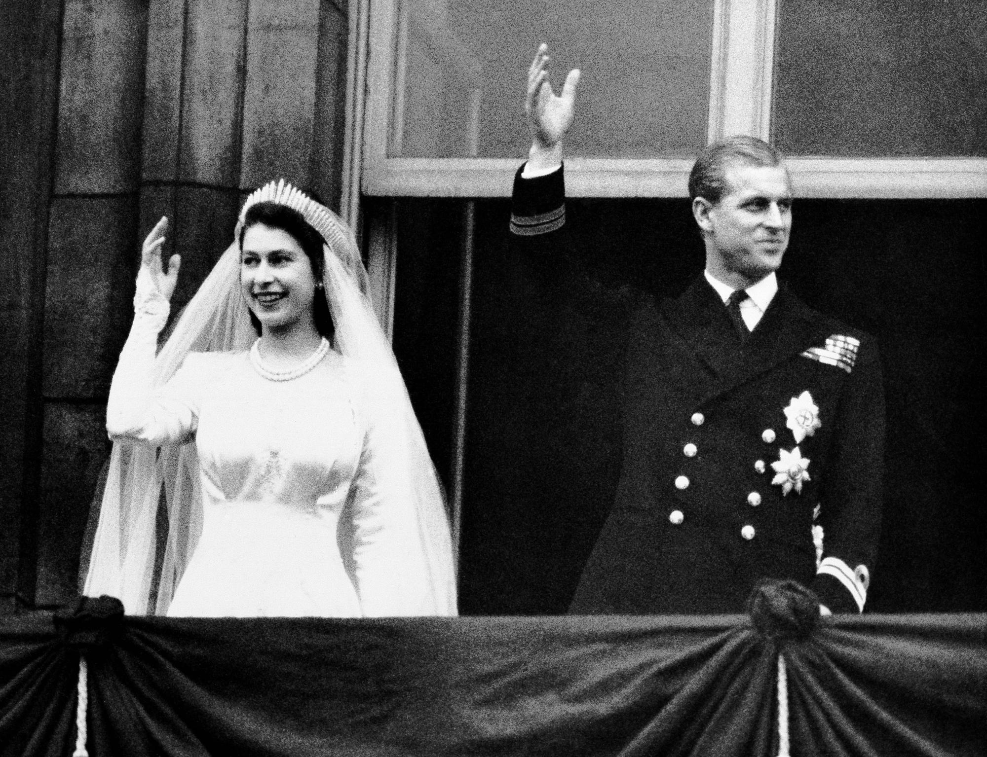 FILE - Britain's Princess Elizabeth and Prince Philip, the Duke of Edinburgh wave to the crowds from the balcony of Buckingham Palace in London, after their wedding, Nov. 20, 1947. Queen Elizabeth II, Britain’s longest-reigning monarch and a rock of stability across much of a turbulent century, has died. She was 96. Buckingham Palace made the announcement in a statement on Thursday Sept. 8, 2022. (AP Photo, File)