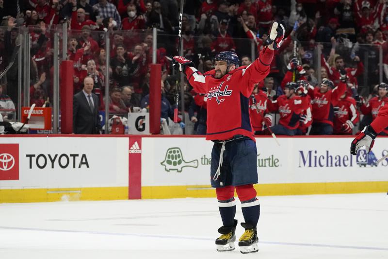 Washington Capitals left wing Alex Ovechkin (8) celebrates after scoring a goal against the New York Islanders during the third period of an NHL hockey game, Tuesday, March 15, 2022, in Washington. The goal gave Ovechkin 767 career goals and sole possession of third on the NHL career list, and most among European players, passing Jaromir Jagr. The Capitals won 4-3 in a shootout. (AP Photo/Julio Cortez)