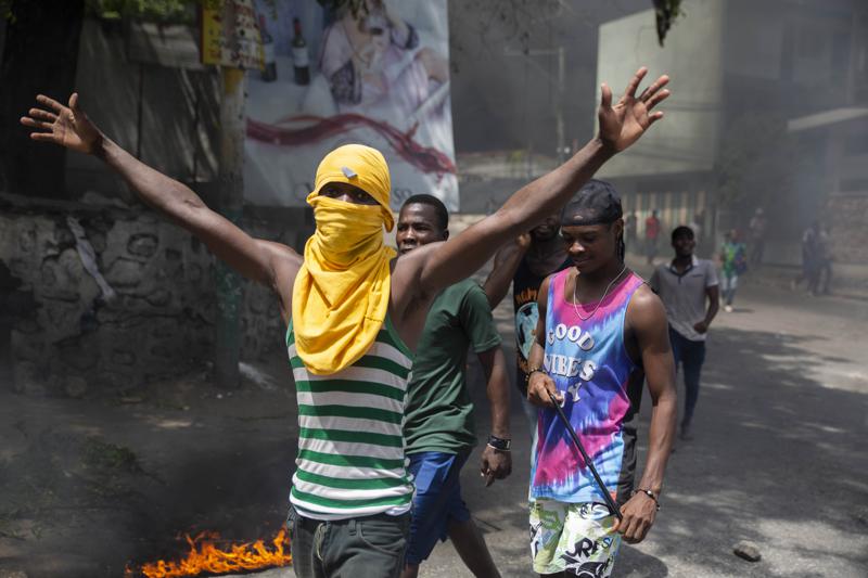 People protest against the assassination of Haitian President Jovenel Moïse near the police station of Petion Ville in Port-au-Prince, Haiti, Thursday, July 8, 2021. Officials pledged to find all those responsible for the pre-dawn raid on Moïse’s home early Wednesday in which the president was shot to death and his wife, Martine, critically wounded. (AP Photo/Joseph Odelyn)