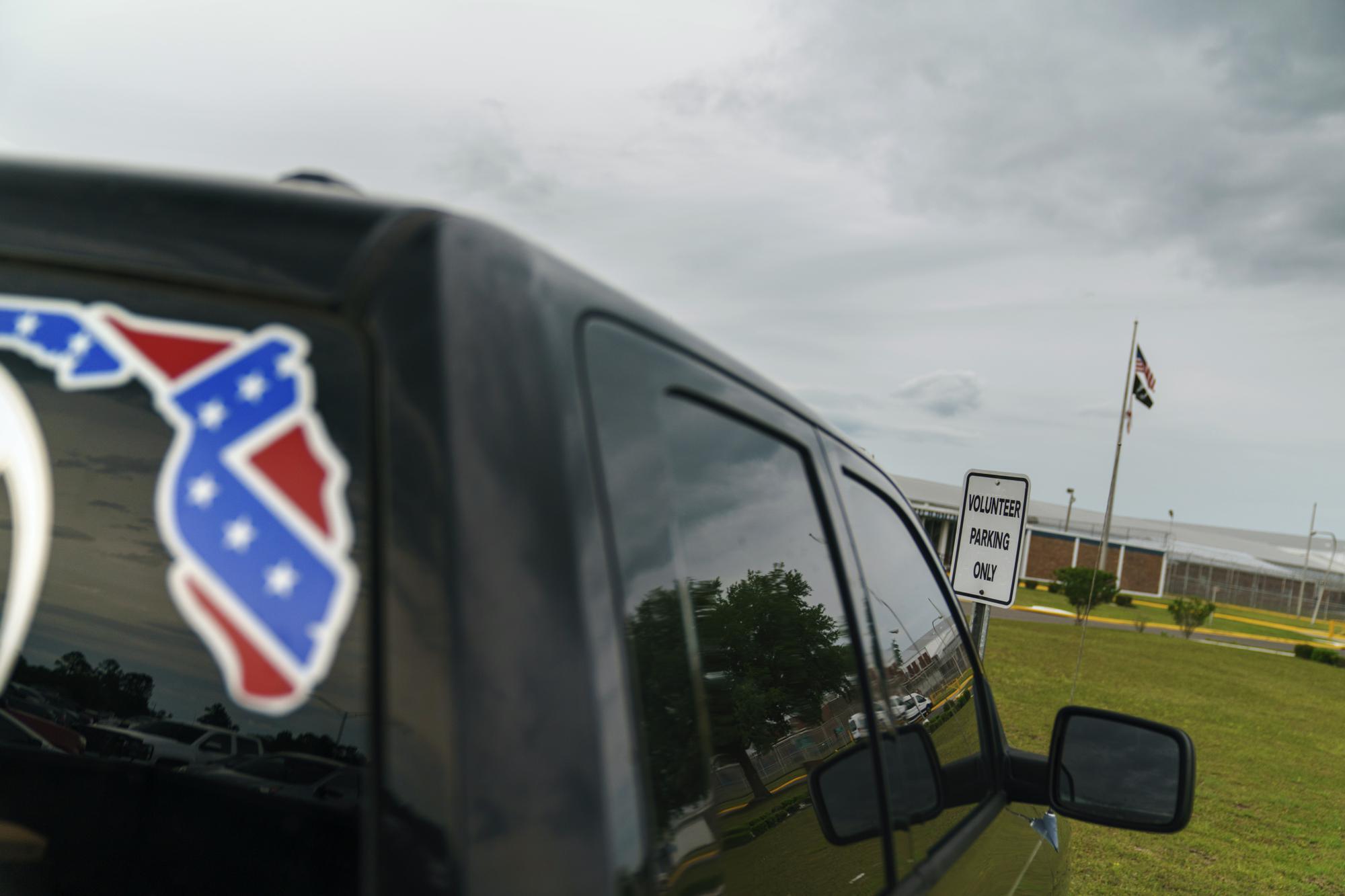 A pickup truck with a Confederate flag-themed decal is parked outside the Reception and Medical Center, the state's prison hospital where new inmates are processed, in Lake Butler, Fla., Friday, April 16, 2021. In 2013, at a prison dorm room in the facility, Warren Williams, a Black inmate who suffered from severe anxiety and depression, found himself in front of Thomas Driver, a white prison guard, after he lost his identification badge, a prison infraction. (AP Photo/David Goldman)