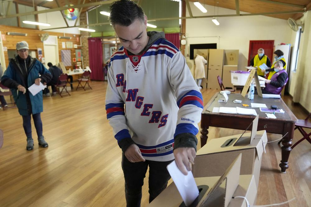 A man casts his ballot at an inner Sydney polling station, Australia, Saturday, May 21, 2022. Australians go to the polls following a six-week election campaign that has focused on pandemic-fueled inflation, climate change and fears of a Chinese military outpost being established less than 1,200 miles off Australia's shore. (AP Photo/Rick Rycroft)