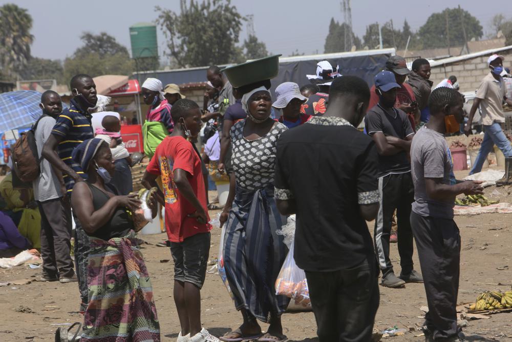 People are seen at a busy market in a poor township on the outskirts of the capital Harare, Monday, Nov, 15, 2021. When the coronavirus first emerged last year, health officials feared the pandemic would sweep across Africa, killing millions and destroying the continent’s fragile health systems. Although it’s still unclear what COVID-19’s ultimate toll will be, that catastrophic scenario has yet to materialize in Zimbabwe or much of Africa. (AP Photo/Tsvangirayi Mukwazhi)