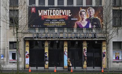 Una mujer frente a un teatro cerrado en Amberes, Bélgica, el 27 de diciembre de 2021. Representantes de actores, artistas y operadores de cine en Bélgica han manifestado su inconformidad con la decisión del gobierno de cerrar salas de cine y otros centros culturales por preocupaciones sobre el coronavirus. (Foto AP/Virginia Mayo)