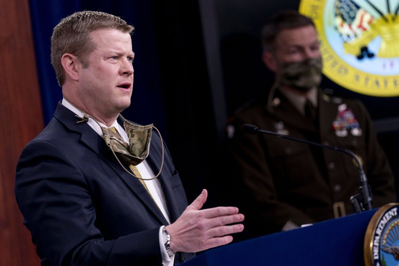 Secretary of the Army Ryan McCarthy, left, accompanied by Gen. James McConville, Chief of Staff of the Army, right, speaks during a briefing on an investigation into Fort Hood, Texas at the Pentagon, Tuesday, Dec. 8, 2020, in Washington. The Army says it has fired or suspended 14 officers and enlisted soldiers at Fort Hood, Texas, and ordered policy changes to address chronic leadership failures at the base that contributed to a widespread pattern of violence including murder, sexual assaults and harassment. (AP Photo/Andrew Harnik)