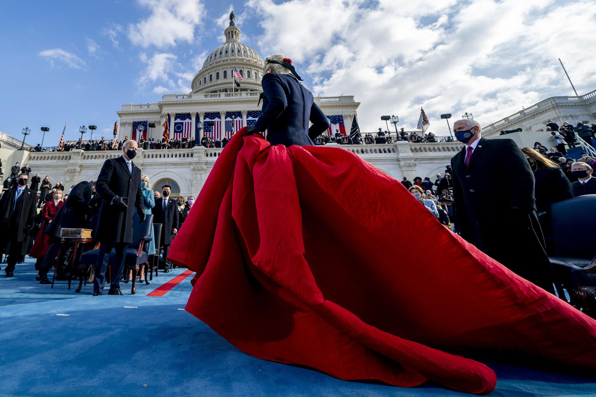 President-elect Joe Biden, left, and Vice President Mike Pence, right, watch as Lady Gaga steps off the stage after performing the national anthem during the 59th Presidential Inauguration at the U.S. Capitol in Washington, on Jan. 20, 2021. (AP Photo/Andrew Harnik)