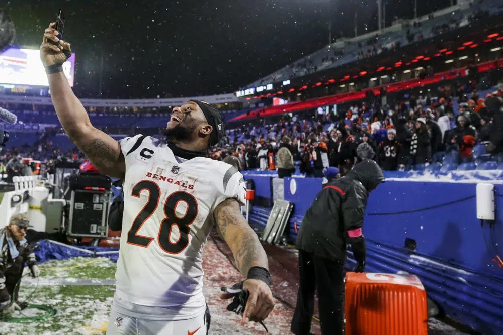 Cincinnati Bengals running back Joe Mixon (28) takes a selfie after the Bengals defeated the Buffalo Bills in an NFL division round football game, Sunday, Jan. 22, 2023, in Orchard Park, N.Y. (AP Photo/Joshua Bessex)