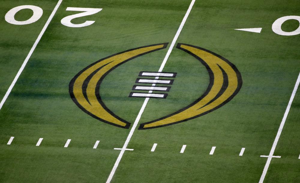 FILE - The College Football Playoff logo is shown on the field at AT&T Stadium before an NCAA college football game in Arlington, Texas, Jan. 1, 2021. The College Football Playoff is set to remain a four-team format through the 2025 season after the administrators who manage the postseason failed to agree on an expansion plan before the current contracts run out. A person involved with the decision told The Associated Press on Friday, Feb. 18, 2022, that the CFP management committee, comprised of 10 conference commissioners and Notre Dame’s athletic director, met by video conference earlier this week. (AP Photo/Roger Steinman, File)