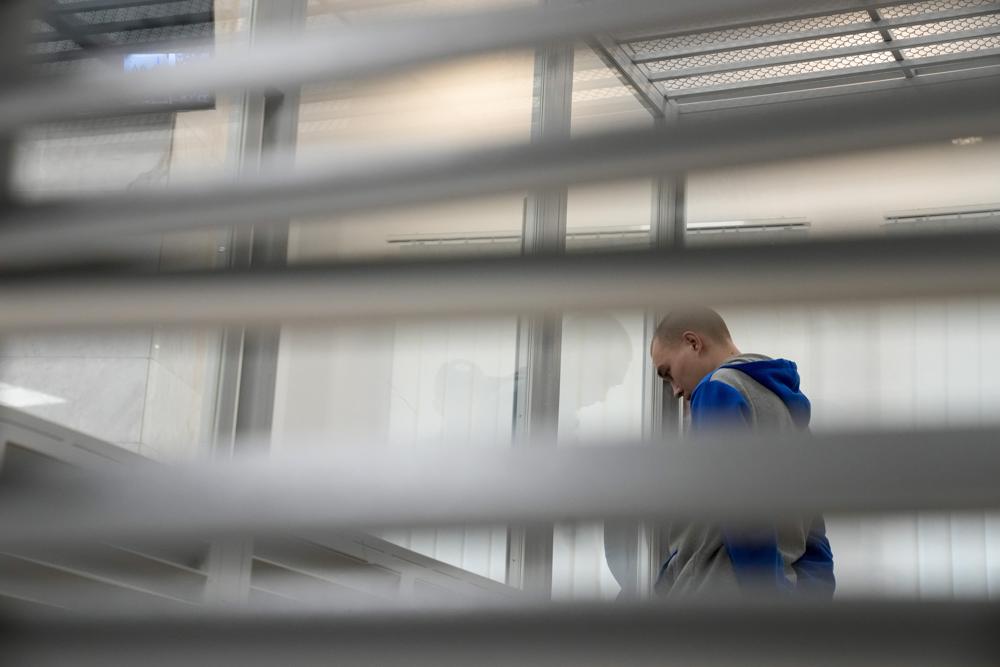 Russian Sgt. Vadim Shishimarin attends a court hearing in Kyiv, Ukraine, Monday, May 23, 2022. The court sentenced the 21-year-old soldier to life in prison on Monday for killing a Ukrainian civilian, in the first war crimes trial held since Russia's invasion. (AP Photo/Natacha Pisarenko)